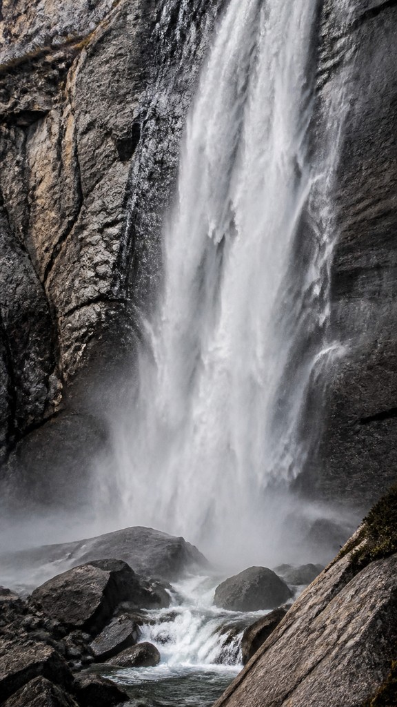 towering waterfall cascading down a cliff — Hyperrealism Art Style