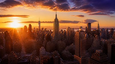 a city skyline panorama at dusk with glowing windows, no people — Golden Hour Landscape Photography Style wallpaper