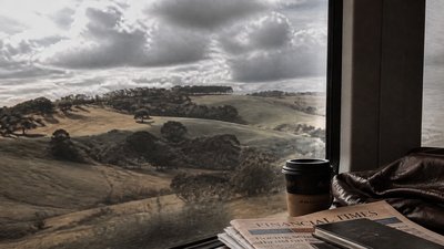 rolling hills with scattered trees under a big dramatic sky, no people — Downtown Girl Aesthetic wallpaper