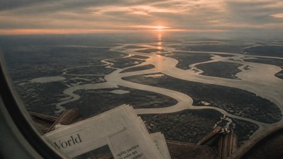 a wide river delta seen from above at sunset, no people — Downtown Girl Aesthetic wallpaper