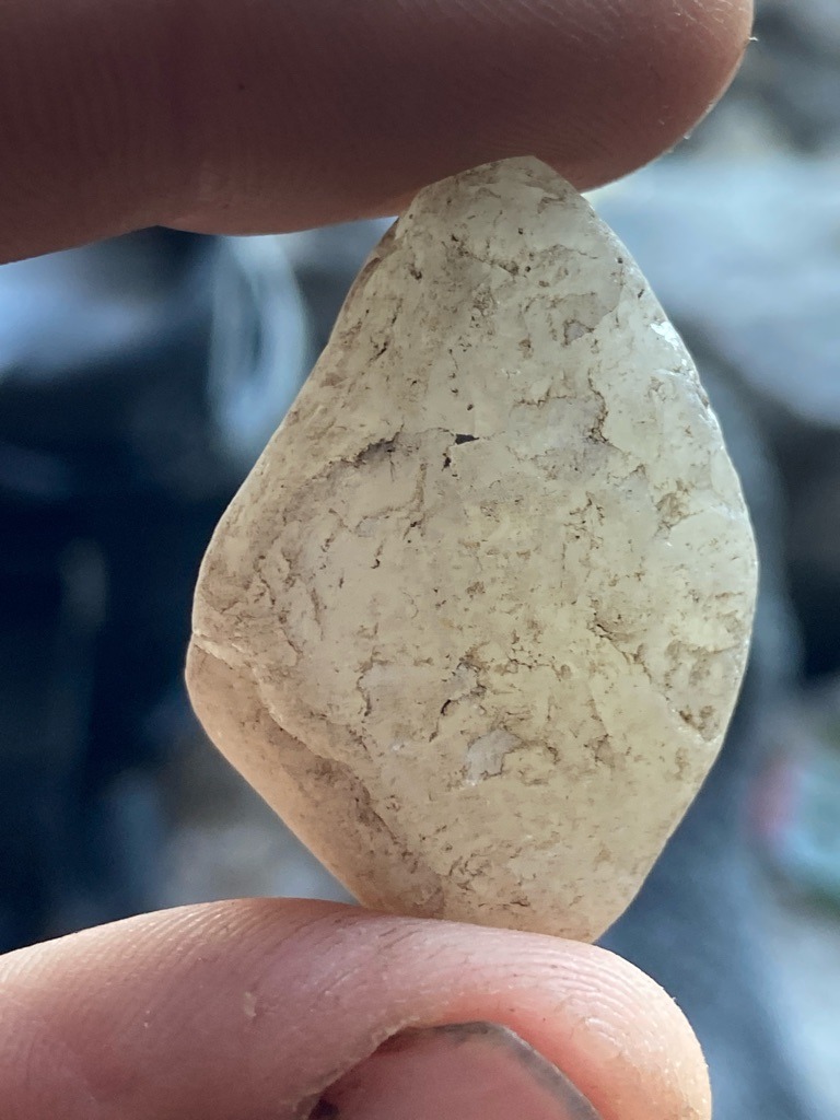 Natural rough stone (likely quartz, quartzite, or heavily included low-grade industrial diamond/bort, but visually consistent with alluvial quartz or silicate mineral given the heavy surface weathering and lack of crystal faces) - Irregular rough pebble / Rounded rough form