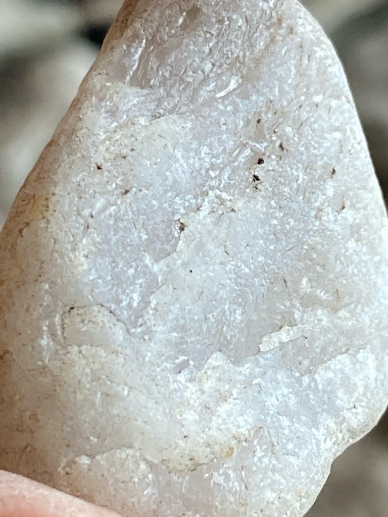 Not a diamond; this specimen appears to be a raw, unpolished mineral or quartz pebble rather than a crystallized diamond. - Irregular, naturally tumbled or weathered pebble shape.