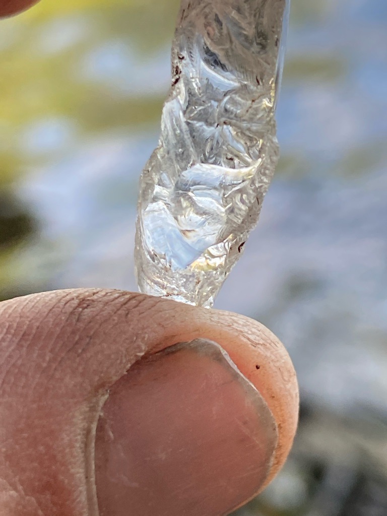 Rough natural crystal (likely quartz or glass given appearance, but evaluated as a raw specimen) - Uncut raw crystal / Irregular elongated fragment