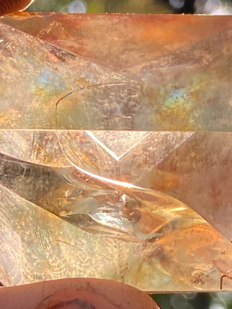 Not a diamond; appears to be a glass simulant, resin cast, or synthetic quartz displaying significant surface wear, internal flow lines, and optical distortions. - Emerald cut / Rectangular step cut