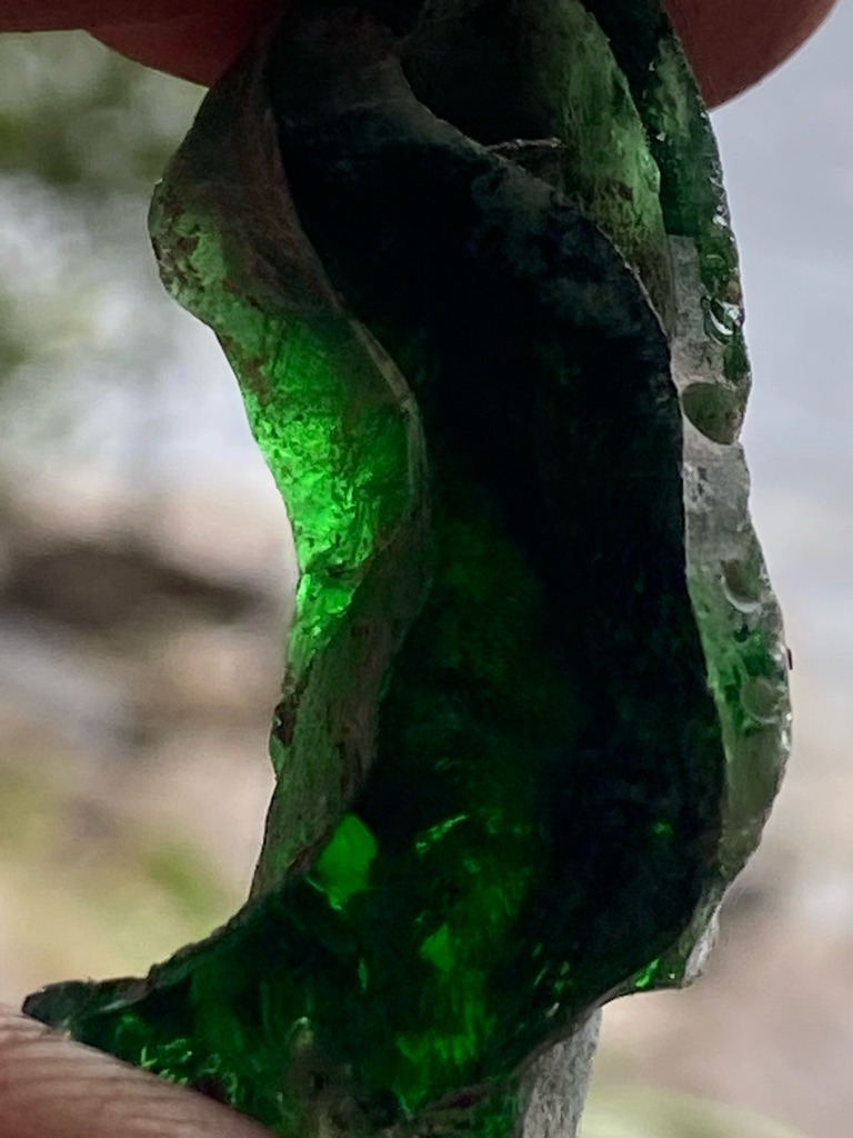 Not a diamond (appears to be green glass slag or fractured bottle glass) - Irregular raw fragment / unstructured shard