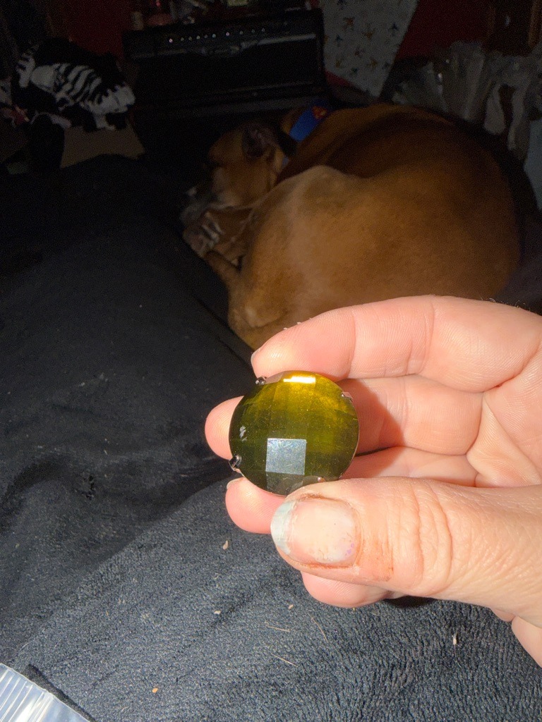 Not a diamond; appears to be a glass or synthetic crystal gemstone due to the irregular large facets, color, and lack of diamond-specific optical properties. - Custom round cabochon/faceted hybrid
