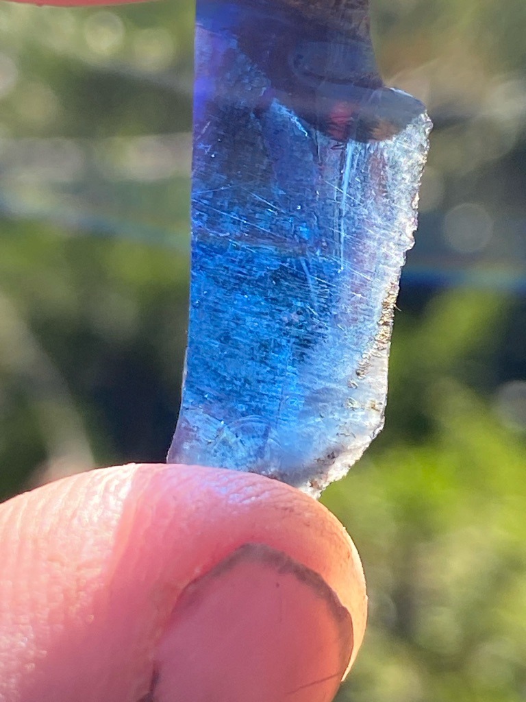 Not a diamond; appears to be a raw mineral or glass fragment, possibly blue glass or synthetic material. - Irregular raw fragment / unstructured slab.