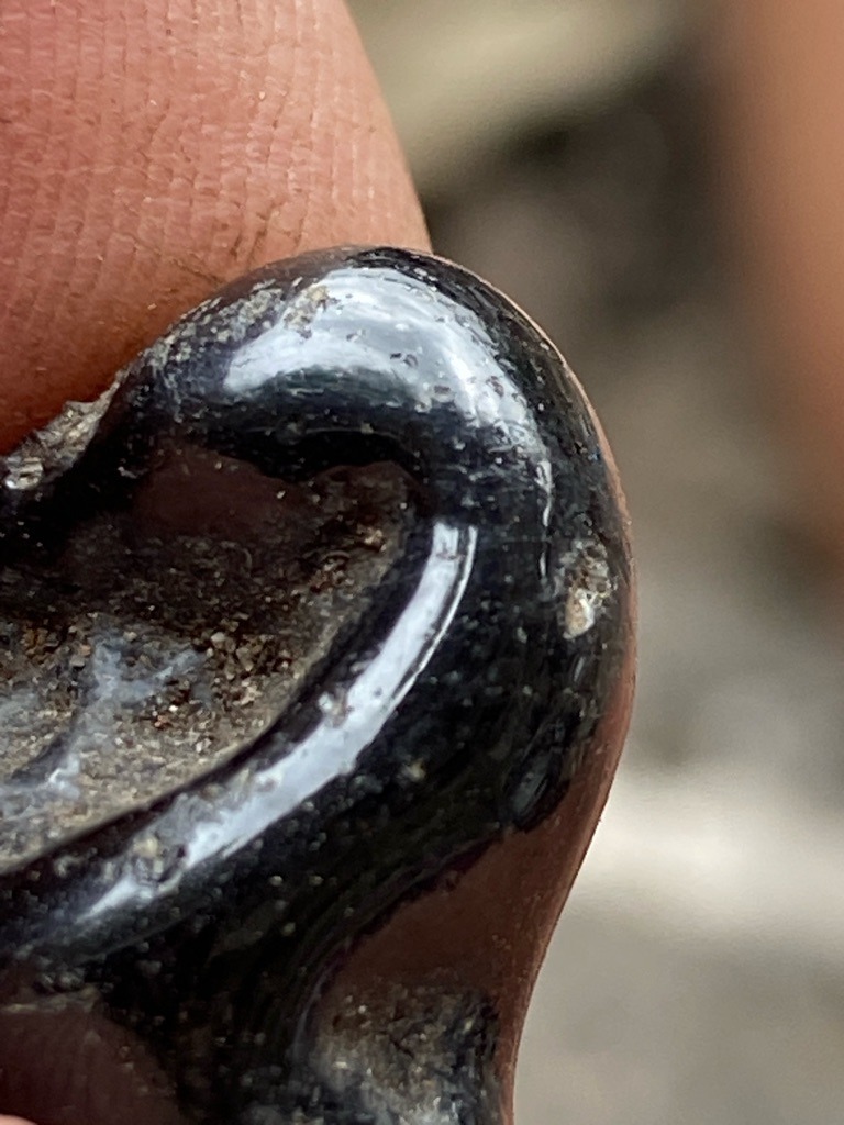 Not a diamond; appears to be industrial slag, glass, or an amorphous dark mineral substance. - Irregular / Undefined organic or molten shape