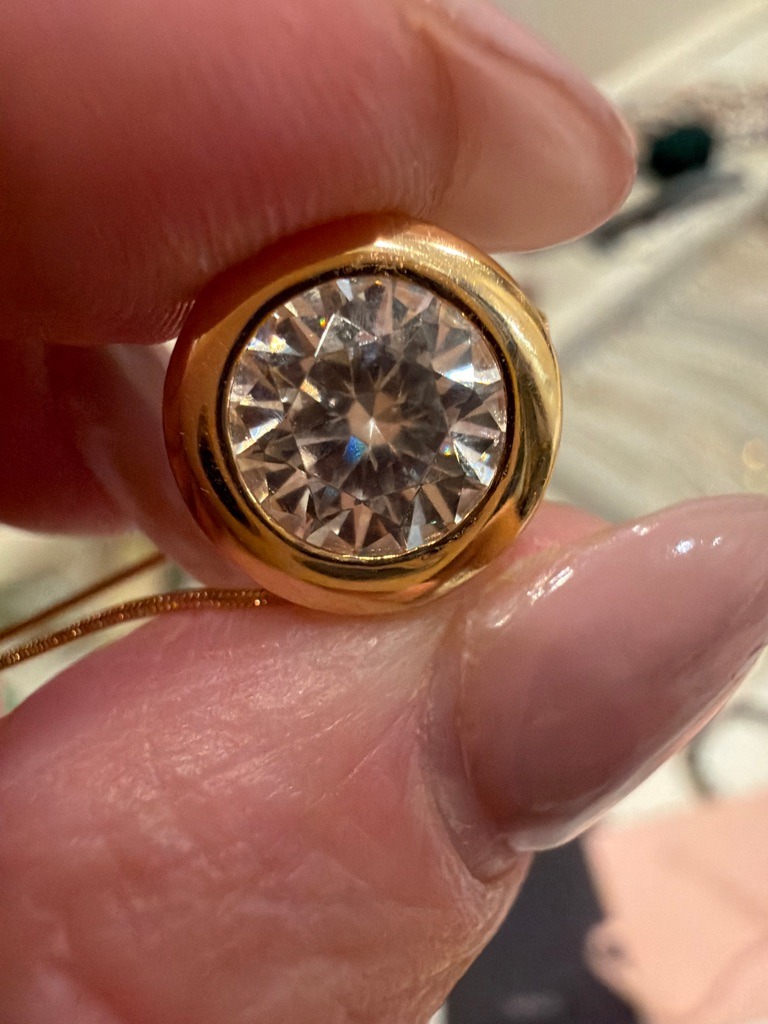 Natural Diamond (likely, though moissanite cannot be definitively ruled out visually due to strong dispersion) - Round Brilliant