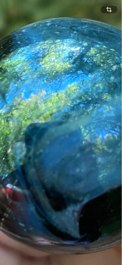 Not a diamond; appears to be a glass marble or decorative glass sphere containing internal inclusions and reflections - Spherical