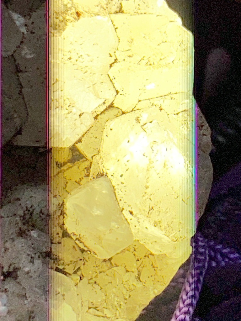 Not a diamond; this image displays rough or crystalline sulfur formations, typically characterized by an intense yellow color and distinct cleavage or tabular crystals rather than carbon-based diamond structure. - Irregular / Crystalline aggregate (non-facetted rough material)