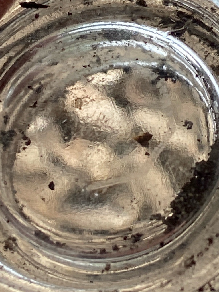 Unable to verify definitively from image; appears to be a glass or quartz inclusion within sedimentary matrix, requiring physical testing to confirm if diamond is present. - Irregular / Rough aggregate