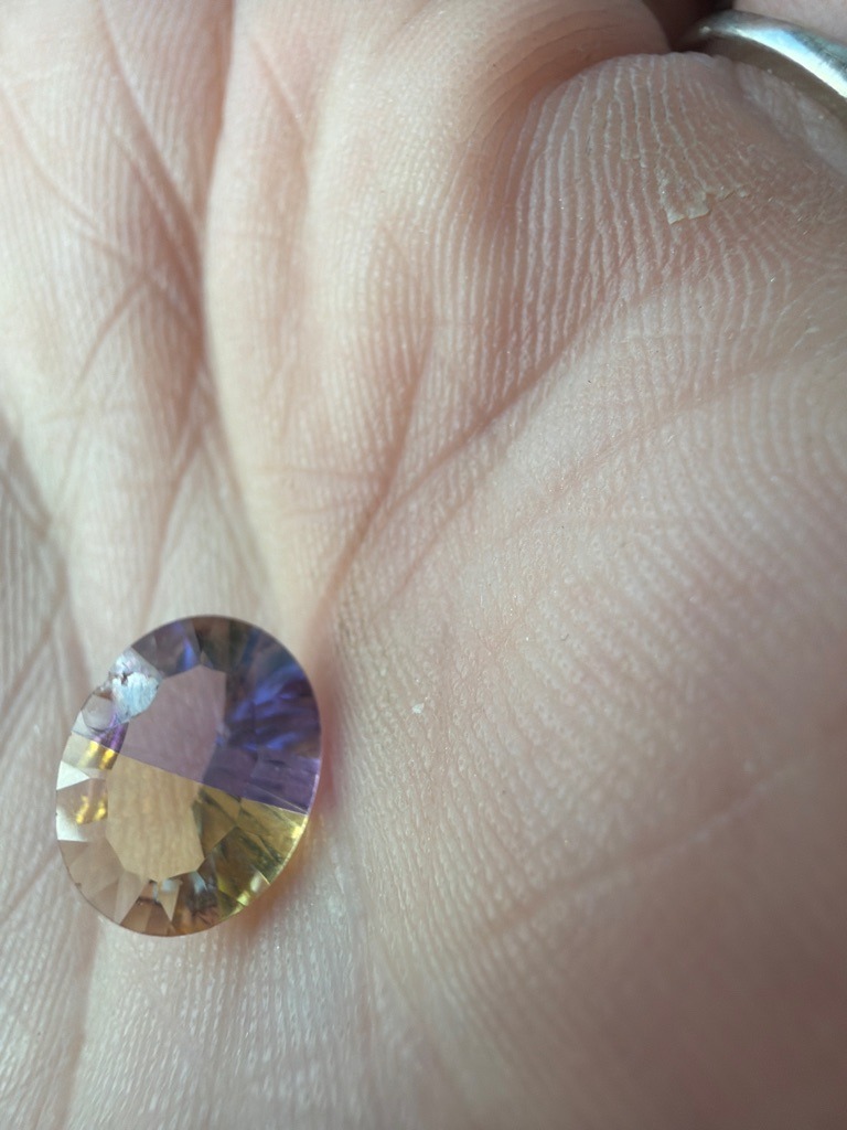 Not a diamond; appears to be a multi-colored quartz or ametrine/coated gemstone - Oval mixed cut