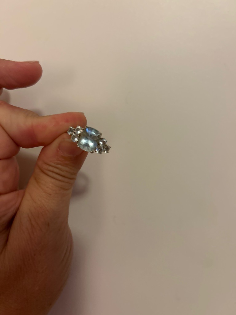 Natural Diamond (or potentially a blue-tinted gemstone/aquamarine depending on material, assuming diamond for prompt focus) - Cushion Cut