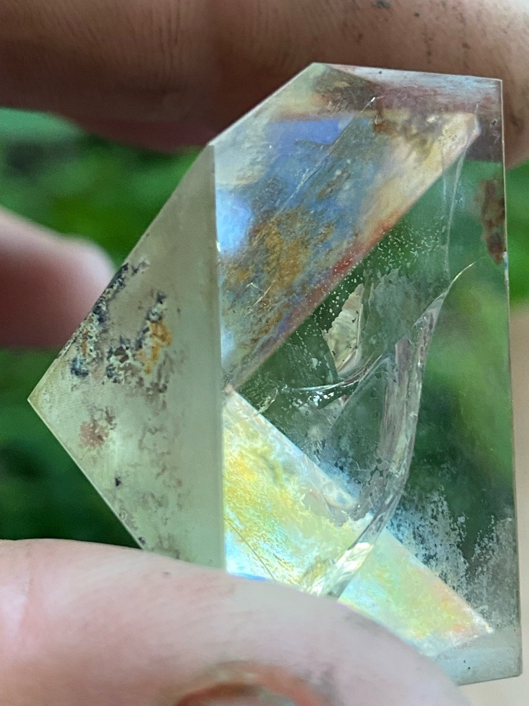 Rough mineral specimen, likely quartz or beryl rather than a faceted gemstone diamond, showing natural crystal habits and heavy inclusions. - Irregular raw crystal shape with cut or polished window facets.