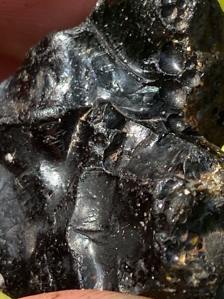 Not a diamond (appears to be raw mineral slag or obsidian with conchoidal fractures) - Rough uncut nodule with conchoidal fracture patterns
