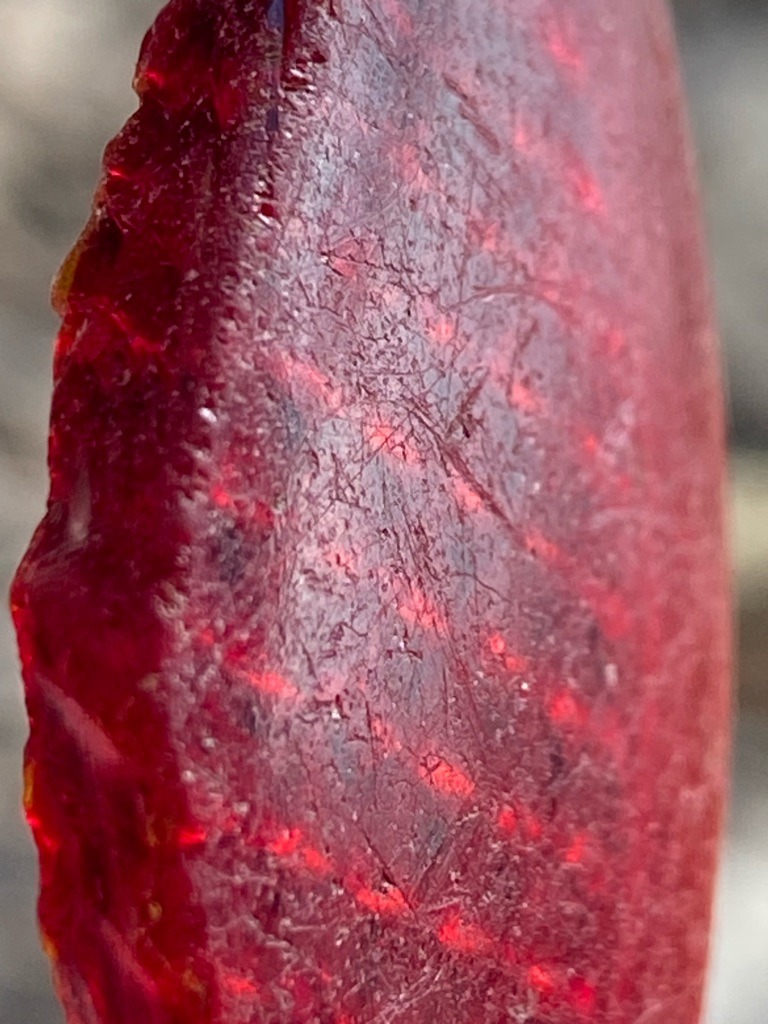 Not a diamond; appears to be a natural or synthetic red mineral/gemstone or rough material with heavy surface texturing. - Irregular / Rough cabochon or fragment