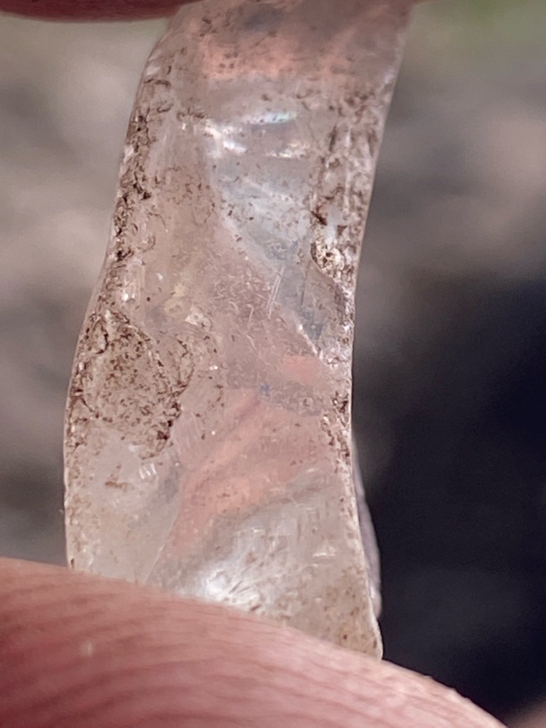 Rough natural crystal specimen, heavily weathered or alluvial, likely quartz or common opal rather than gemstone-quality diamond given the surface texture, fracture patterns, and lack of characteristic diamond crystal faces (octahedron/dodecahedron). However, assuming standard diamond analysis criteria applied to rough alluvial diamond. - Uncut raw crystal fragment / irregular alluvial pebble shape