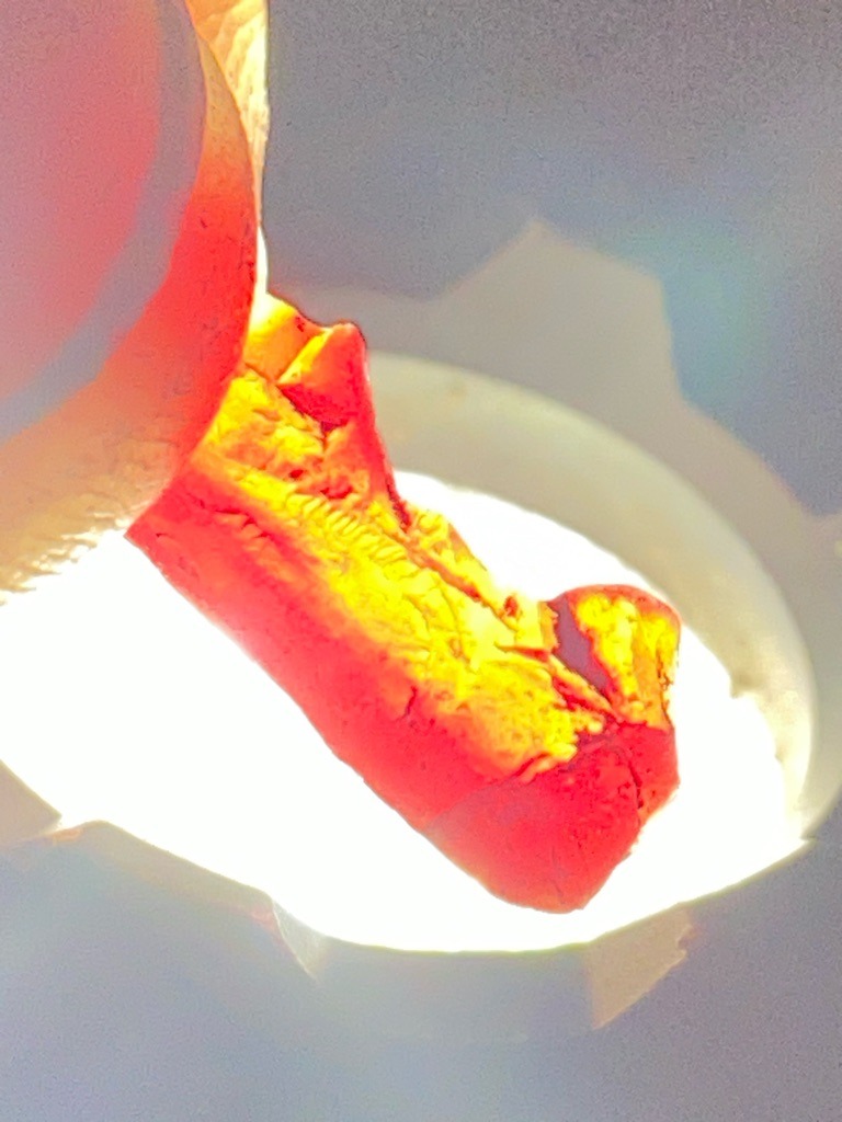 Not applicable - The image appears to show a piece of molten or glowing hot material, likely metal or glass in a crucible, rather than a polished gemstone or a diamond. - Not applicable