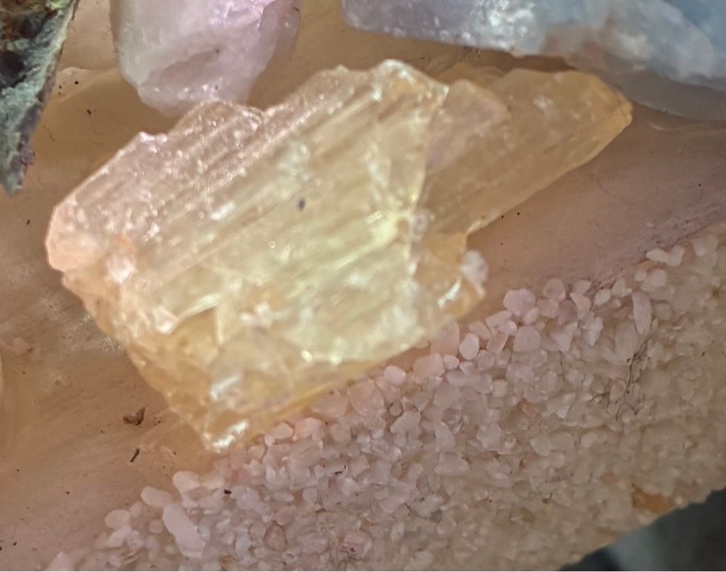 Not a diamond; this is a rough, unpolished crystal specimen, likely quartz or calcite colored yellow by mineral inclusions. - Rough, uncut crystal crystal habit with irregular elongated prismatic form.