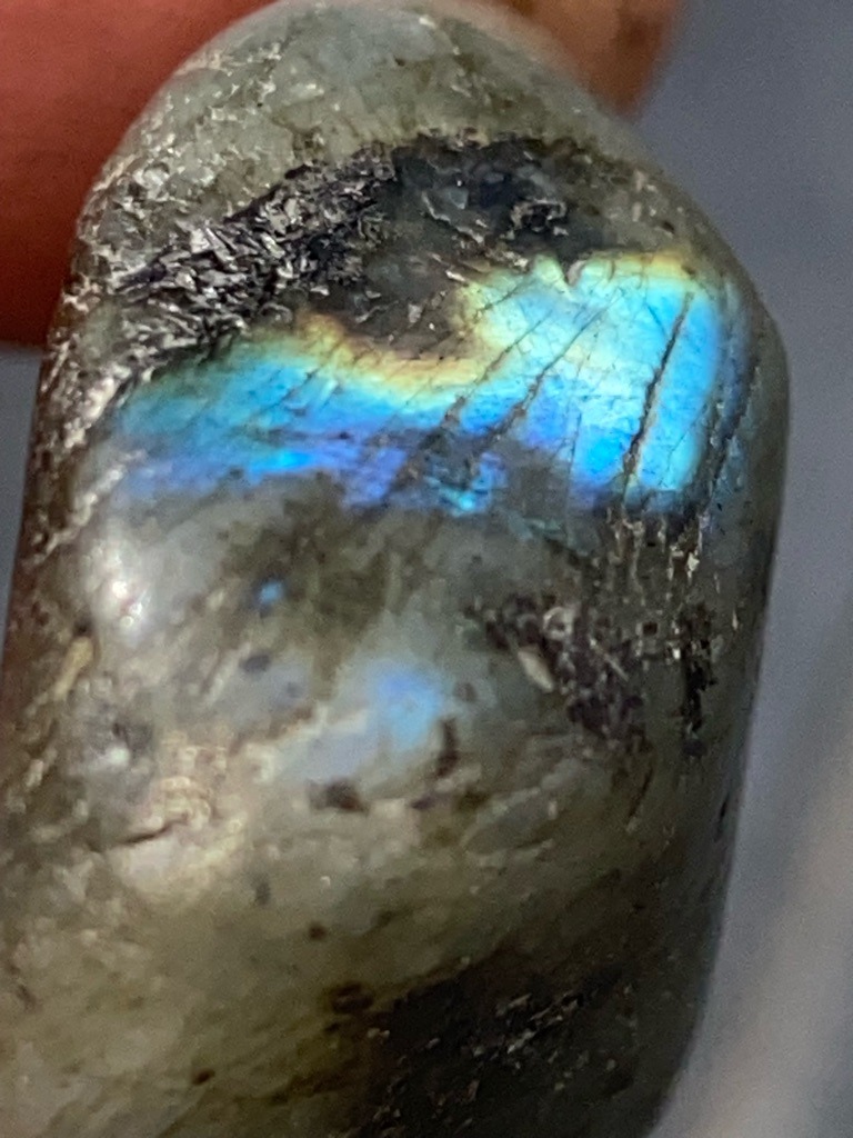 Not a diamond; this is a mineral specimen, specifically a polished piece of Labradorite feldspar exhibiting labradorescence. - Irregular tumbled/freeform cabochon