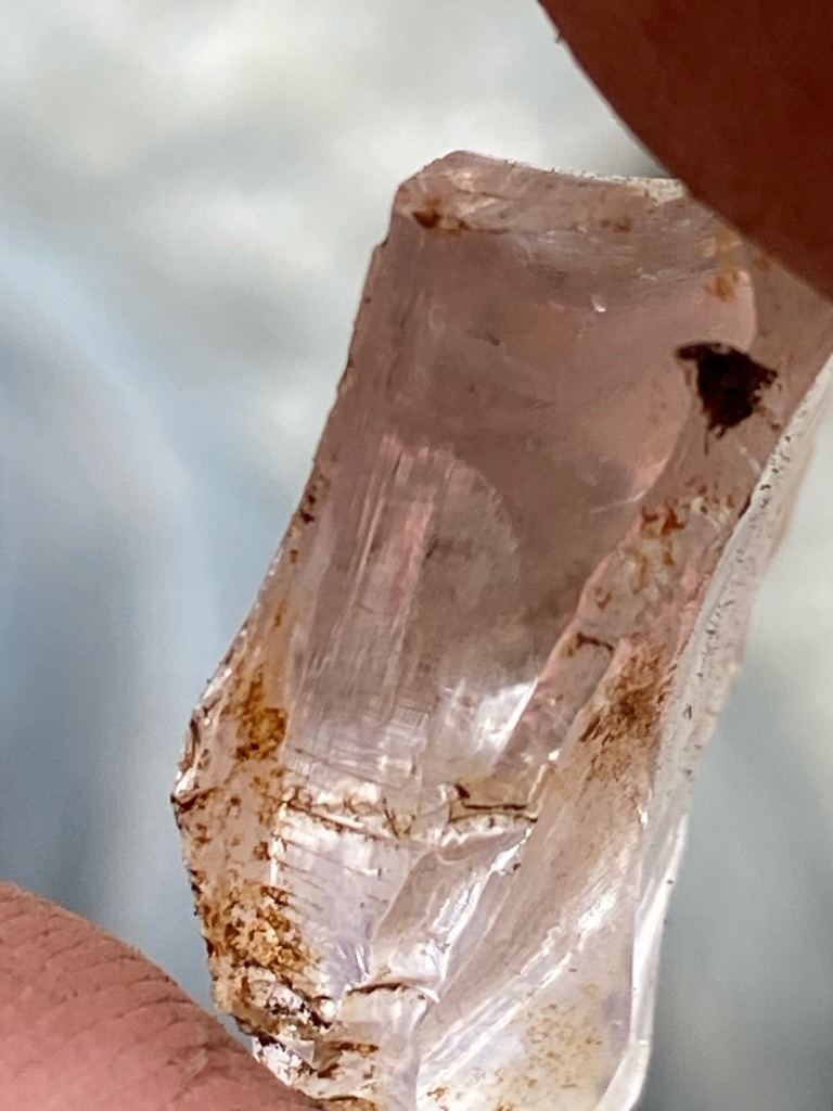 Natural rough mineral crystal, likely quartz, beryl, or possibly uncut corundum/topaz rather than diamond due to crystal habit and striated prismatic faces. - Rough uncut crystal shard with irregular, elongated prismatic form.