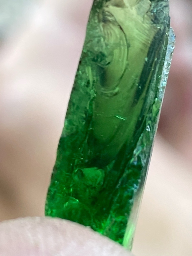 Not a diamond; this specimen appears to be green glass or industrial slag, showing characteristic conchoidal fracture patterns. - Rough irregular shard or fragment, non-standard cut.
