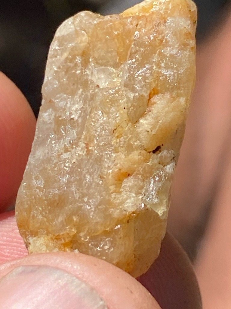 The image appears to show a raw, unpolished crystal aggregate or quartz/citrine-like mineral specimen rather than a standard faceted diamond, though rough industrial-grade diamond crystals can sometimes appear unstructured; based on visual texture, this is likely not a gem-quality diamond. - Rough crystal / Uncut natural mineral form