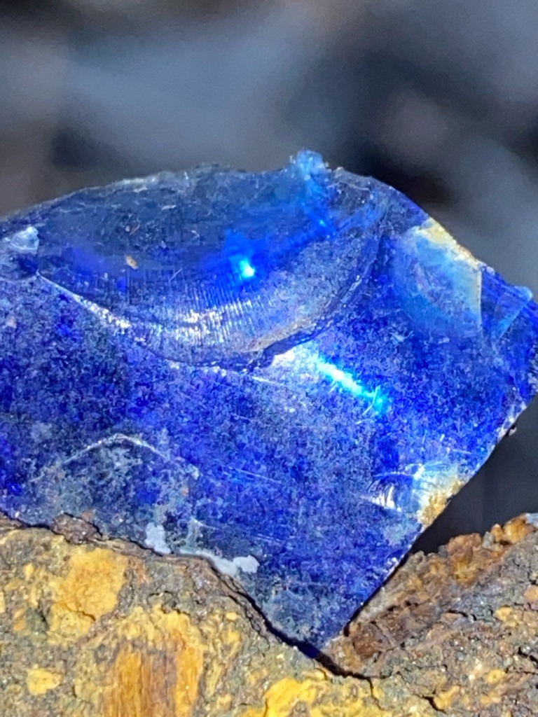 Not a diamond; tentatively identified as blue slag glass or industrial waste containing metallic inclusions. - Rough, irregular, and fractured (un-cut).