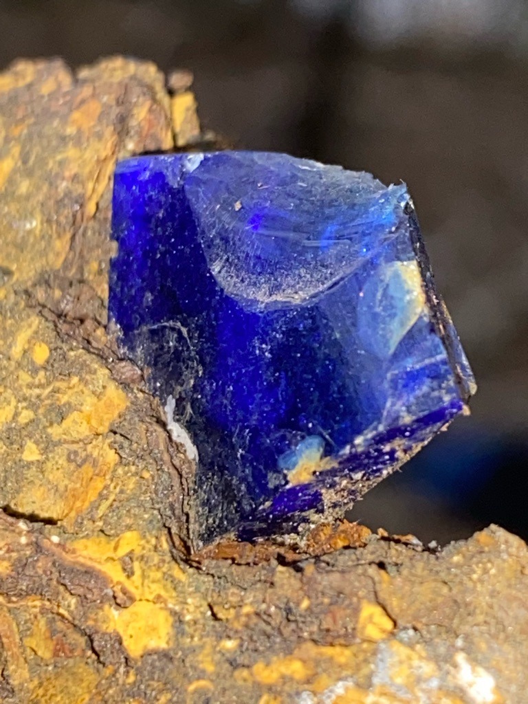 The specimen in the image is not a diamond; it appears to be a natural mineral specimen, likely Linarite or Azurite embedded in a limonite/ironstone matrix. If it were a diamond, it would be classified as a 'Fancy Deep Blue' natural diamond, though the crystal structure shown (monoclinic or orthorhombic appearance) is inconsistent with diamond's cubic system. - Rough / Uncut crystal (subhedral to euhedral crystal form).