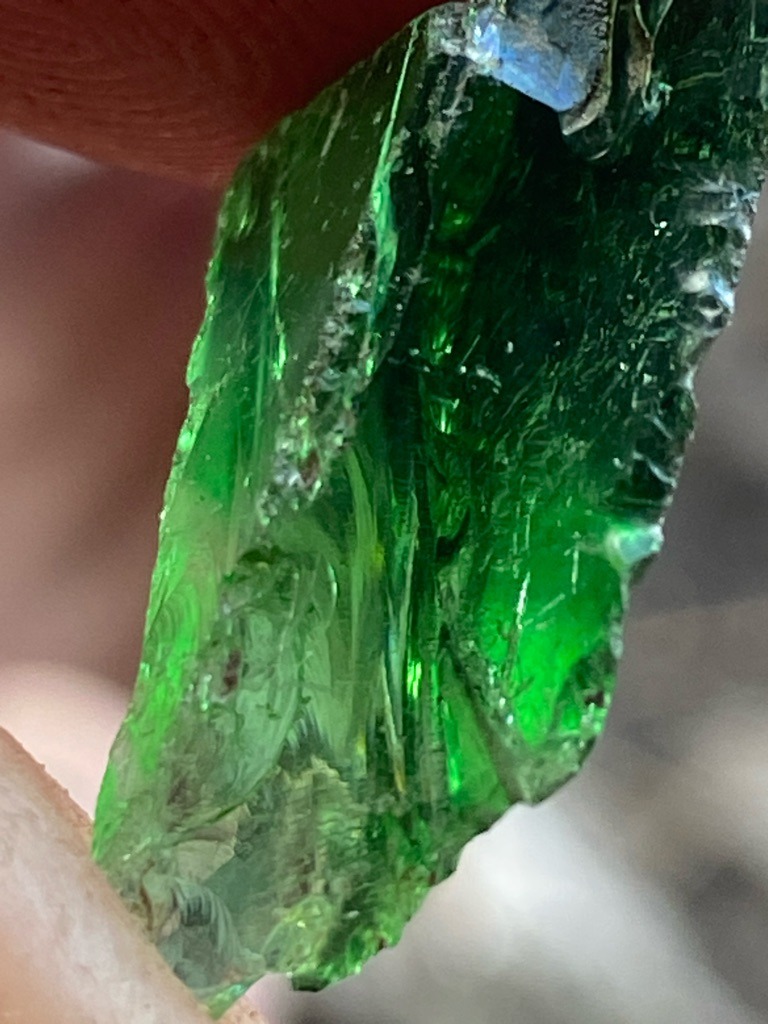 Not a diamond; this specimen appears to be green glass or a green mineral crystal such as rough tourmaline or diopside, lacking diamond crystal habit and optical properties. - Rough crystal / raw irregular form