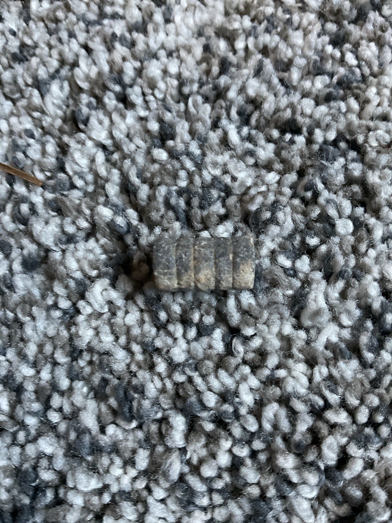 The object in the image is not a diamond. It appears to be a discarded metal piece, possibly a crimp, ferrule, or piece of hardware. - Cylindrical with multiple ridges/segments.