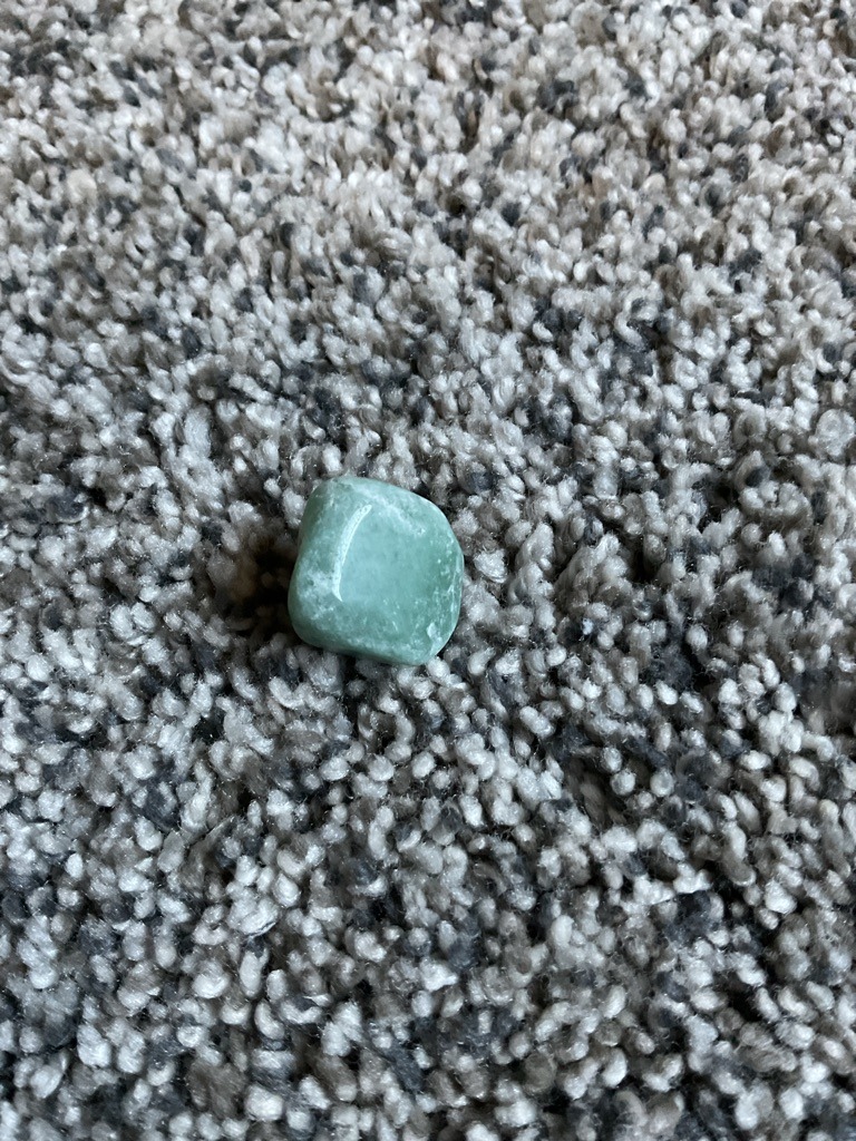 Non-Diamond. The specimen possesses characteristics consistent with a common green ornamental stone, such as Adventurine, Jadeite, or Nephrite, rather than a diamond. - Rough Tumbled / Freeform. The stone lacks a professional gemological cut and is instead rounded and polished into a pebble-like shape.