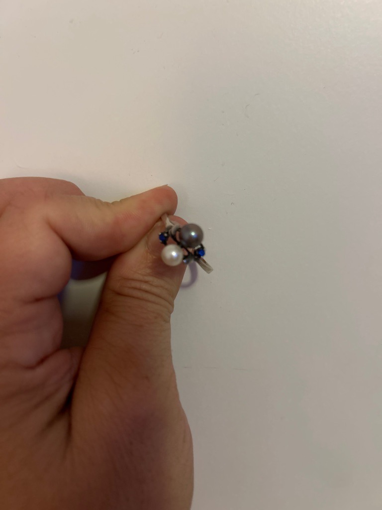Not a diamond; the jewelry piece features pearls and colored gemstones (sapphires or similar) set in a multi-stone ring. - Round (Pearls and accent gemstones are round/spherical/cabochon cut)