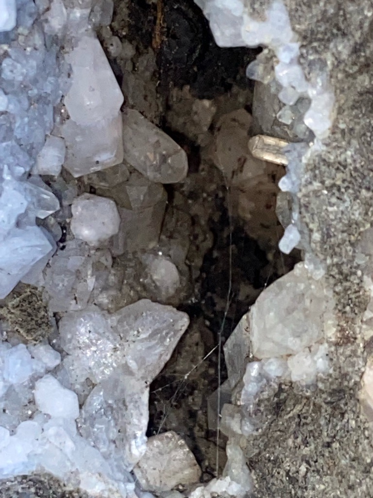 Not a diamond; the image shows raw quartz crystal formations in a geode or vug, likely containing quartz or calcite. - Natural rough crystal habit, predominantly hexagonal prismatic and rhombohedral forms typical of quartz.