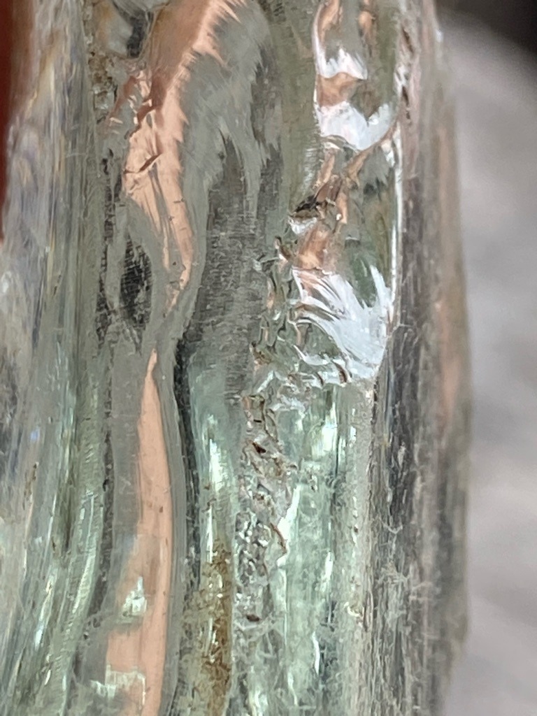 Not a diamond; appears to be industrial slag glass, quartz crystal, or quartz composite material based on the conchoidal fractures, flow lines, and amorphous surface texturing. - Rough crystal / Raw amorphous chunk with no standard faceted gemstone shape.