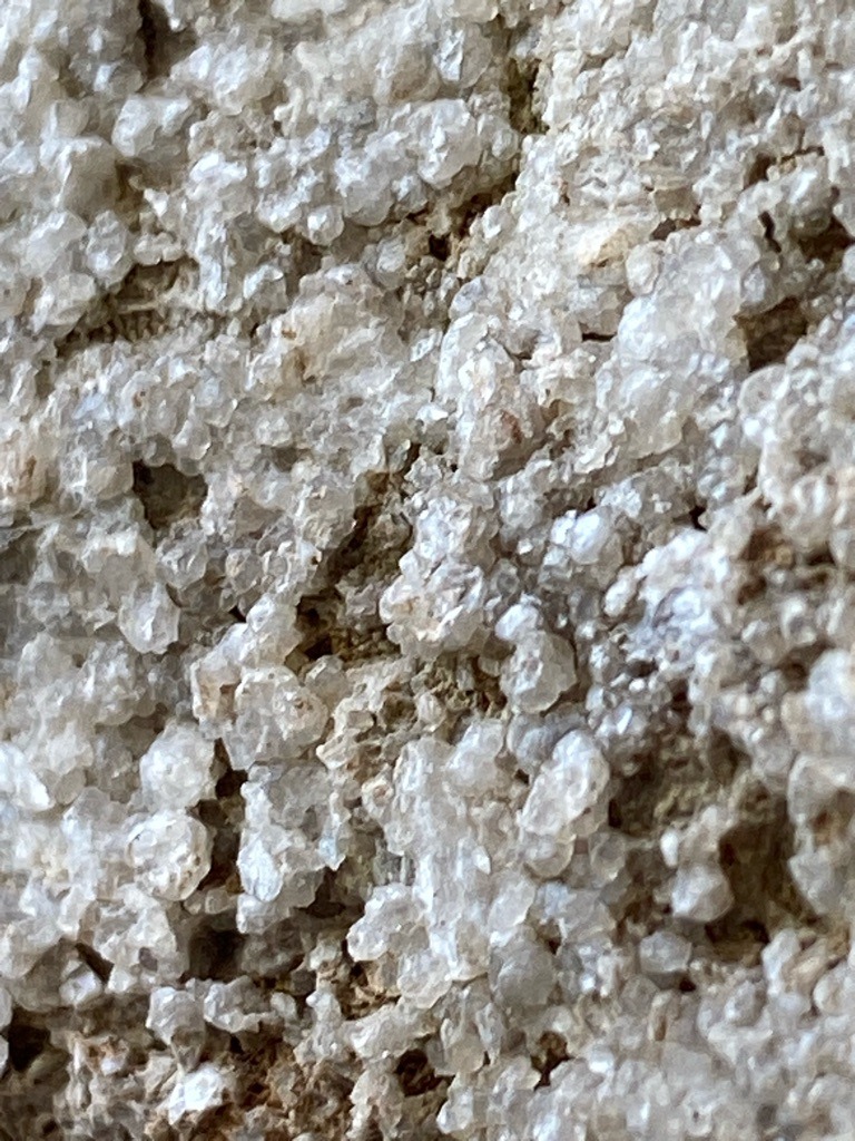 Not a diamond; this image depicts an aggregate of small, crystalline mineral formations, likely quartz druzy or a similar mineral crust (such as calcite or salt crystals), not a faceted or isolated gemstone. - Irregular crystalline aggregate / Druzy crust