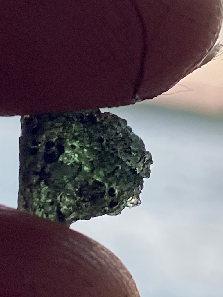 Not a diamond; this specimen appears to be an olive-green tektite (specifically Moldavite), which is a natural impact glass formed by a meteorite impact approximately 15 million years ago. - Irregular raw or rough fragment, unpolished natural shape