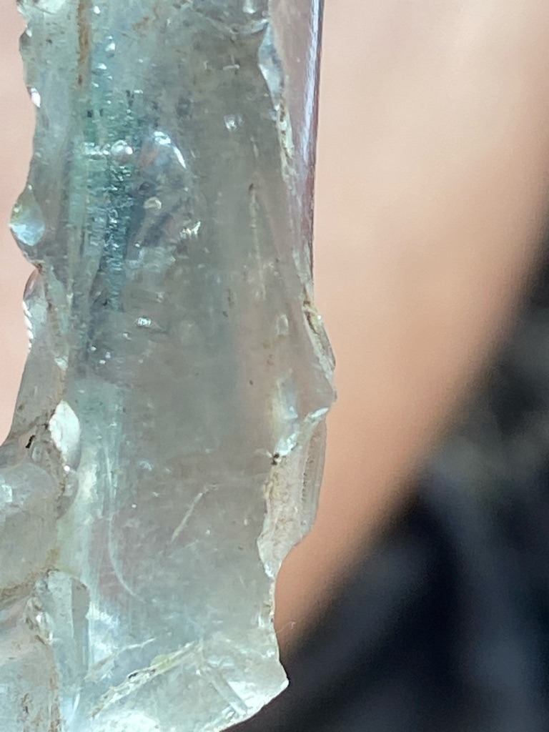 Not a diamond; this specimen appears to be rough, unpolished glass slag or quartz crystal, lacking the specific crystal habit and refractive properties of a true diamond. - Raw, uncut, irregular elongated crystal or glass chunk
