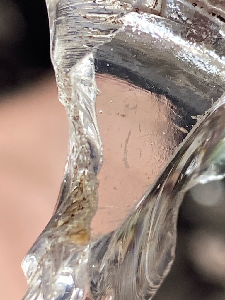 Not a diamond; this specimen appears to be glass or quartz/slag with conchoidal fractures, typical of amorphous or non-gem materials rather than crystalline diamond. - Irregular / Raw fragment with conchoidal fracture