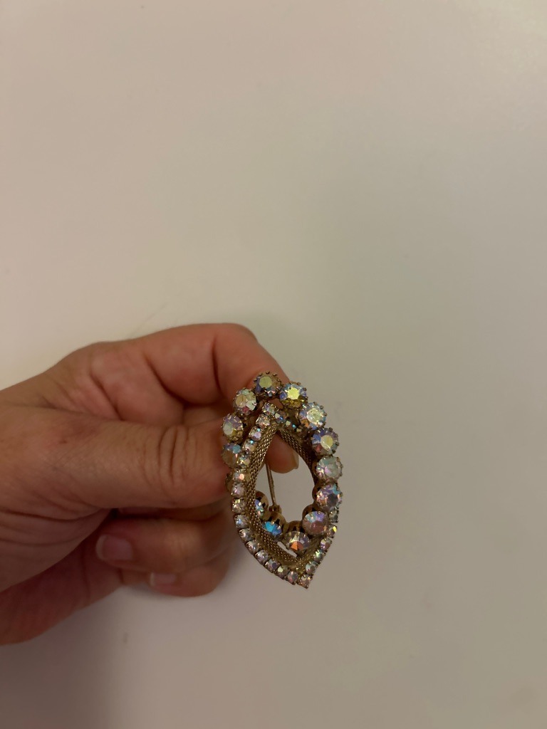 Not a diamond; these are coated or treated glass rhinestones (commonly known as Aurora Borealis or AB crystals) set in vintage costume jewelry. - Mixed (primarily round chatons and small marquise/navette rhinestones)