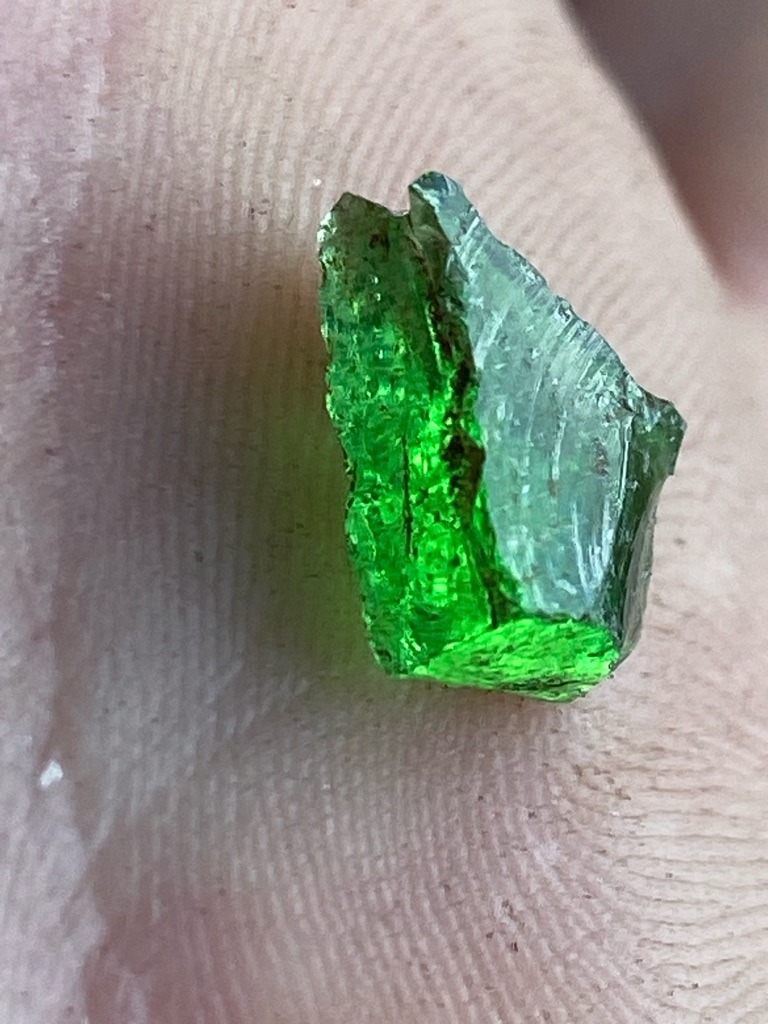 Not a diamond; this is a rough green gemstone, visually consistent with green tourmaline or chrome diopside, though further testing is required for definitive identification. - Uncut rough crystal fragment