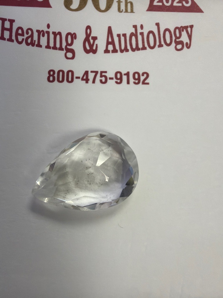 The image shows a faceted gemstone, but based on visual indicators like the irregular multi-facet pattern and lack of standard high-dispersion optical properties, this appears to be either a quartz, glass, or cubic zirconia rather than a genuine diamond. If confirmed as diamond, it would be Natural. - Pear (Teardrop)