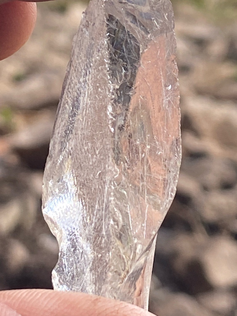 Not a diamond; this specimen appears to be rough quartz or a similar clear mineral/silica crystal rather than crystalline carbon. - Rough uncut crystal shard with irregular elongated habit.