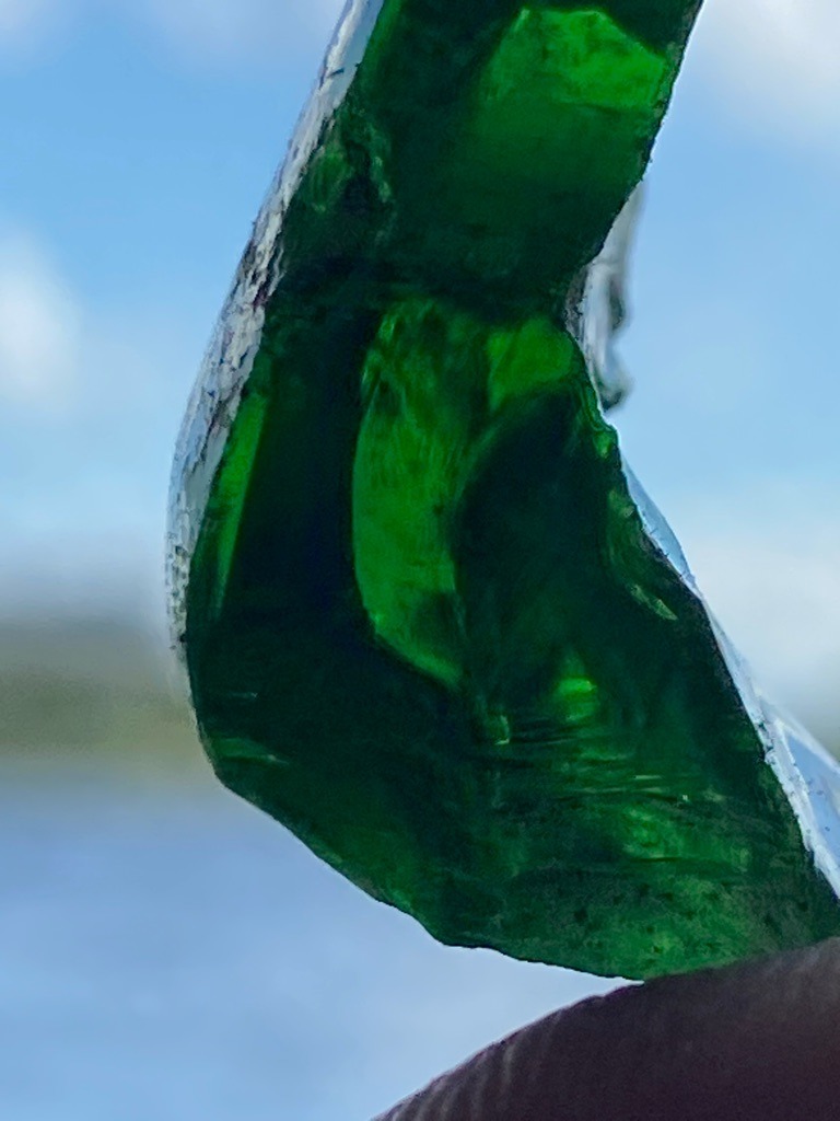 Not a diamond; this specimen appears to be green glass or an amorphous silicate material showing conchoidal fracture. - Irregular / Raw fragment