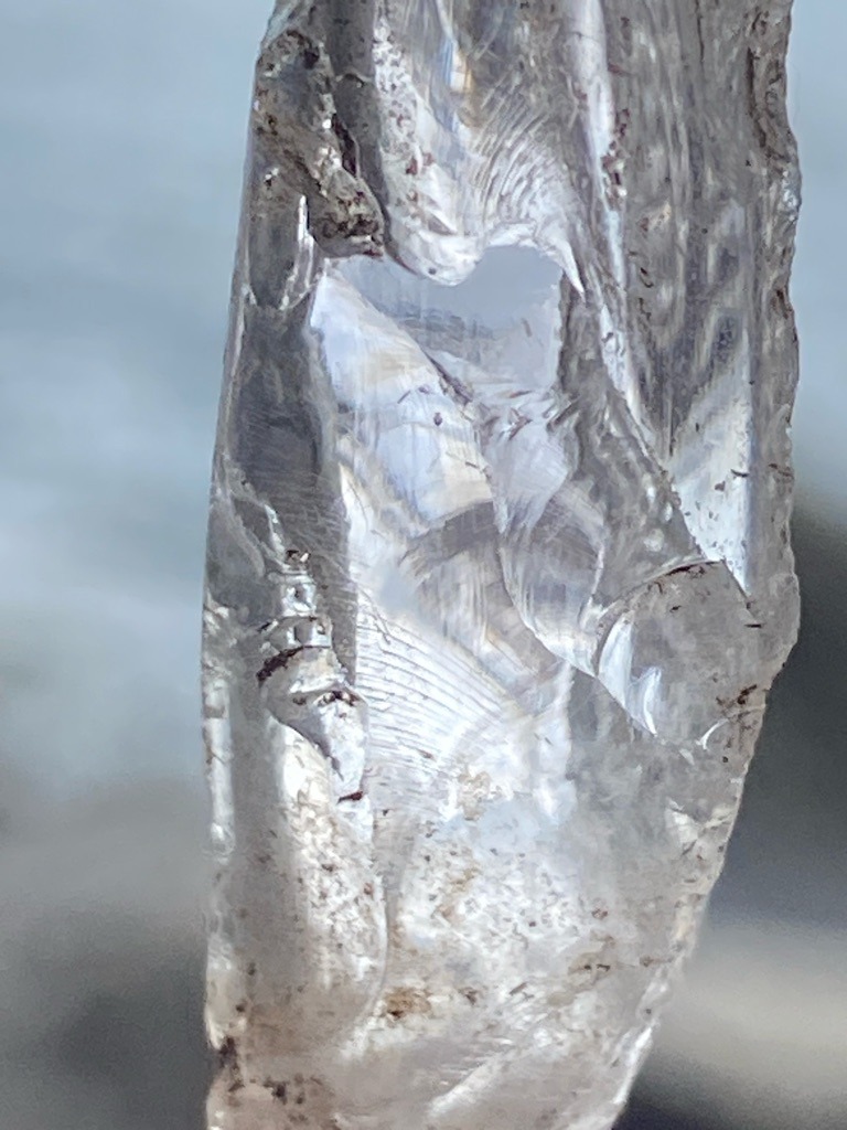 Not a diamond; this is a natural water ice formation (icicle), displaying conchoidal fracture patterns characteristic of ice rather than crystalline gemstone structures. - Irregular elongated formation (icicle structure, not a faceted gemstone shape).