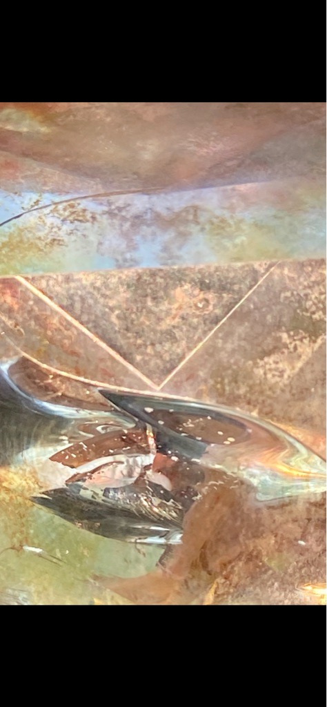 Unable to determine definitively from the extreme macro abstract imagery provided, which appears to show a polished crystal surface, reflective metal, or possibly a distorted reflection rather than a standard faceted diamond. - Not applicable due to extreme close-up abstract perspective.