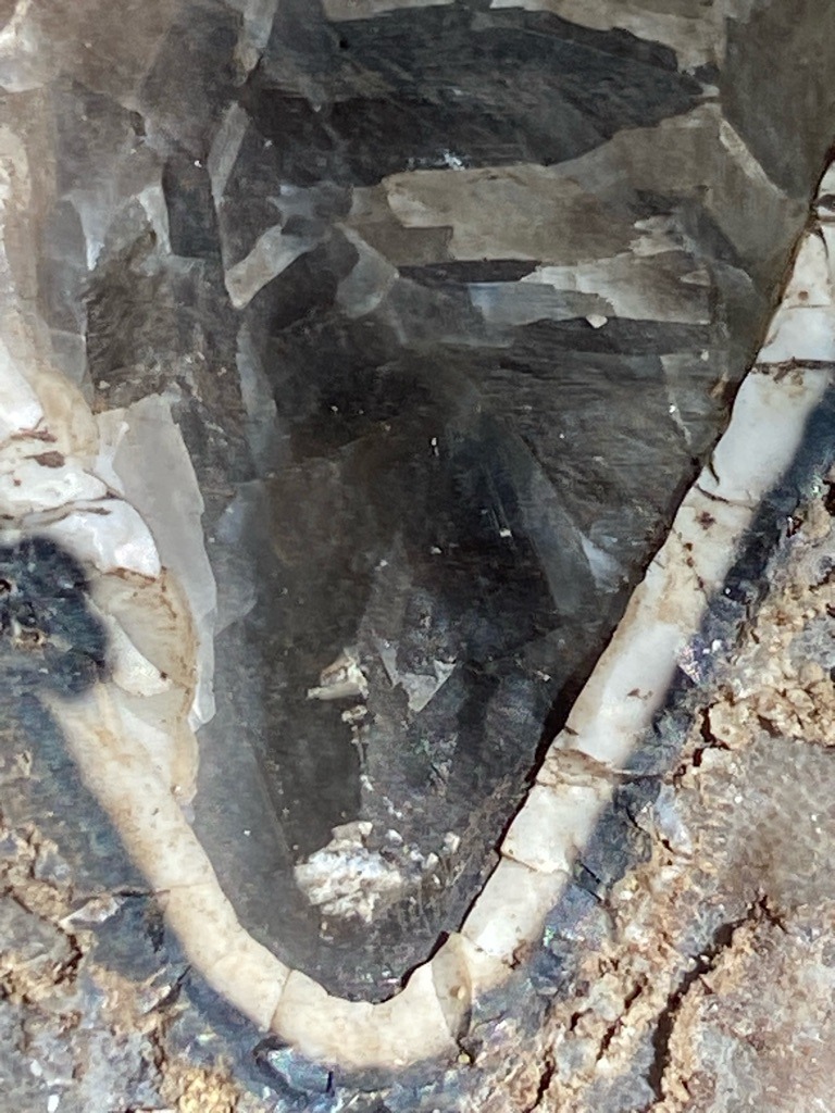 Not a diamond; this is a geode or crystal cavity lined with quartz or another mineral matrix, showing rough rock formations rather than a cut diamond. - Irregular / Natural matrix cavity (Not applicable)