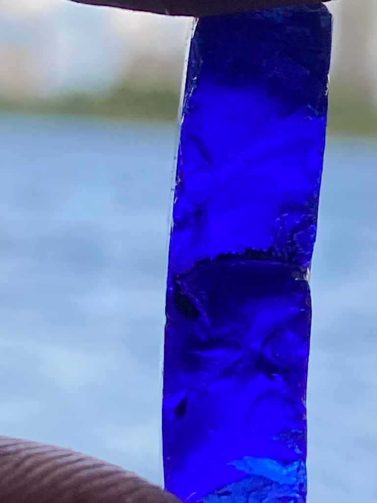 Not a diamond (appears to be a blue glass or synthetic material, not carbon-based) - Rough elongated bar / uncut rectangular slab