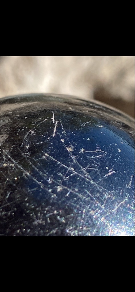 Not a diamond, appears to be an opaque stone, mineral sphere, or glass with heavy surface scratches. - Spherical / Cabochon-like